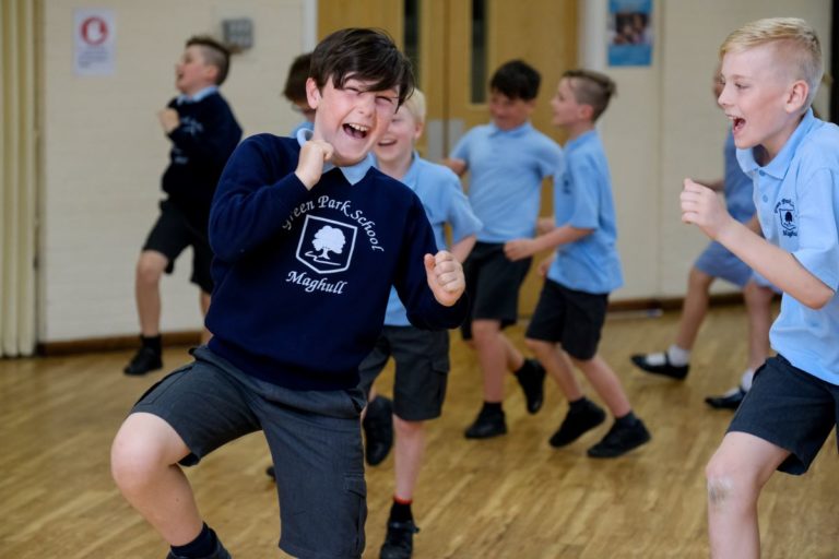 A group of Key stage 2 pupils enjoy an interactive drama workshop in school hall