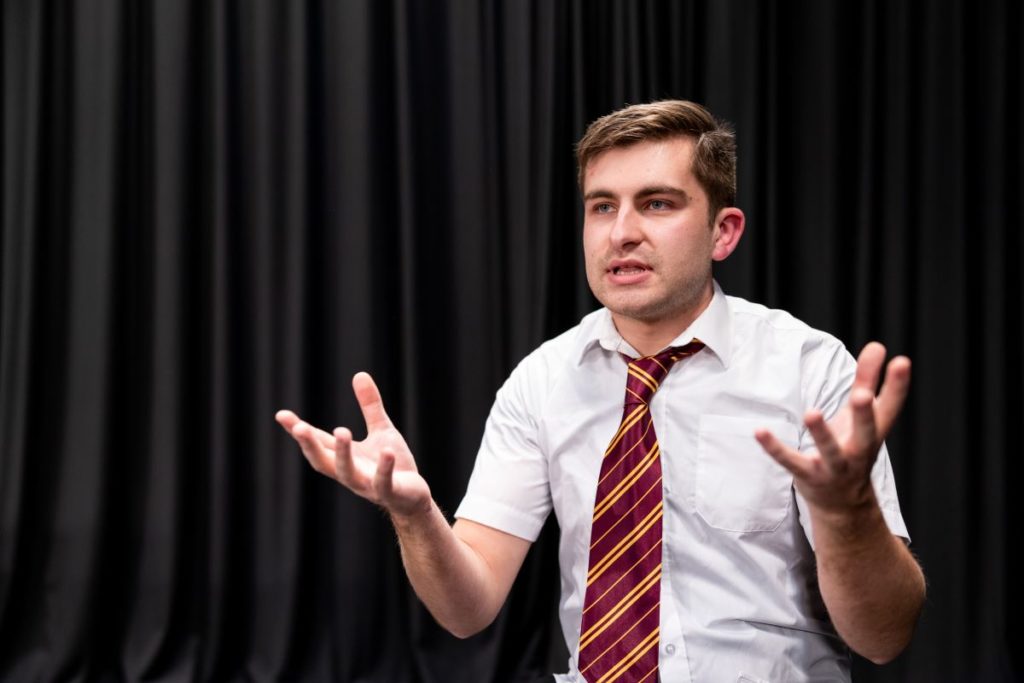Actor performing in school drama workshop exploring the theme of homophobia