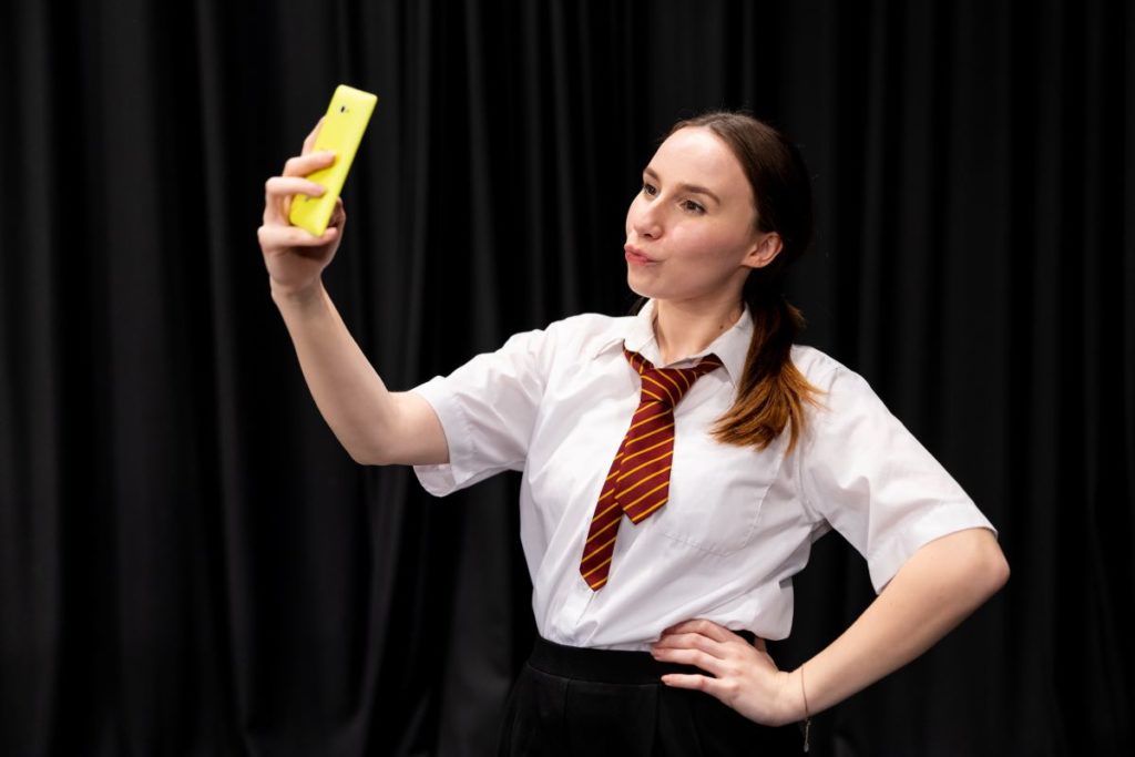 Workshop drama leader taking a selfie as part of online safety theme