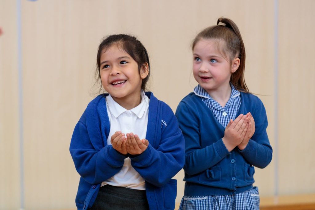 two key stage one pupils engaged in a drama workshop about Traditional Tales